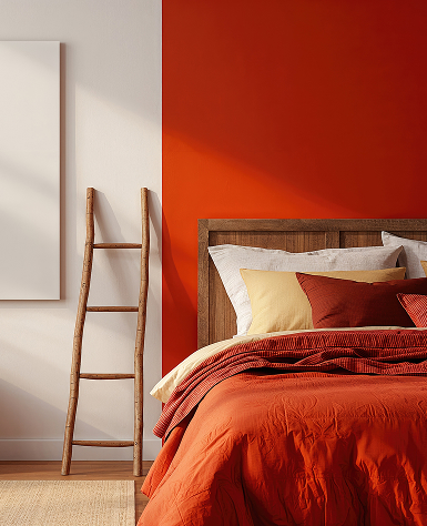 Cozy bedroom with a warm, vibrant color scheme. Orange bedding, wooden headboard, simple ladder-style shelf, orange and white walls enhance comfort.